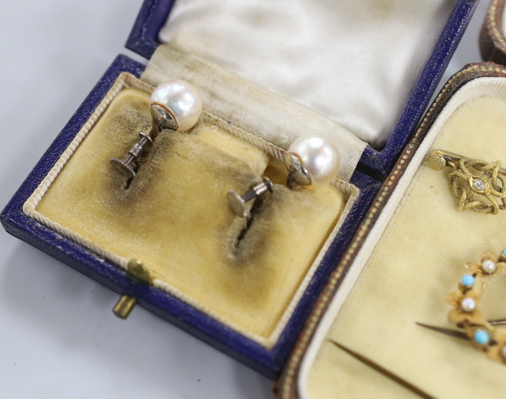 A pair of 9ct white metal and cultured pearl ear clips, a circular brooch, arrow and quiver brooch and four stick pins